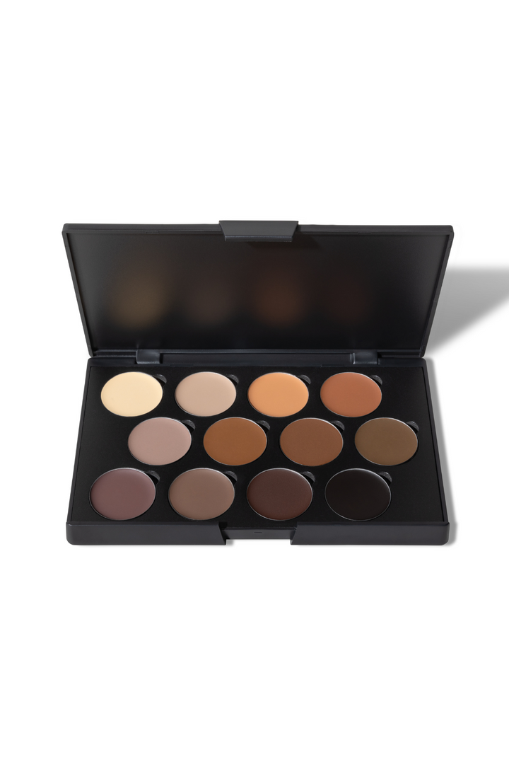 An open black makeup palette displays twelve shades of brown and beige foundation.